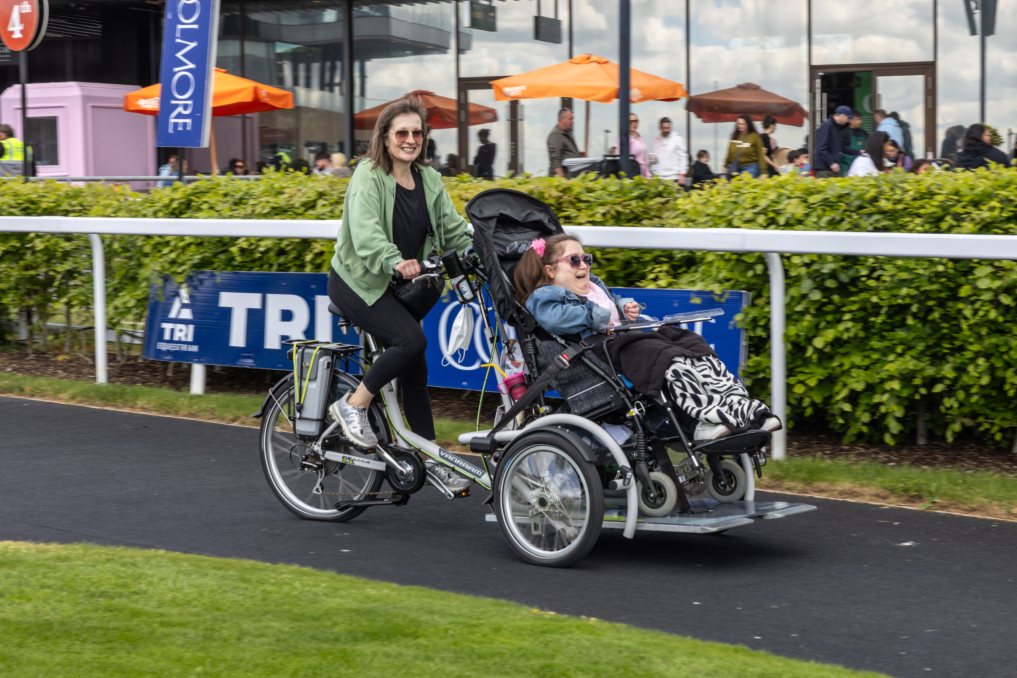 People on tandem wheelchair accessible bike.